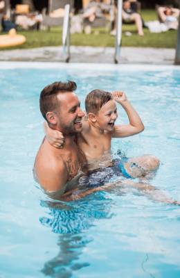 Vater und Sohn beim spielen im Hotelpool