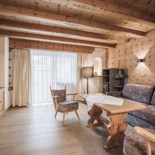 juniorsuite kirchspitz6 Gemütliches Zimmer mit Holzdekor und modernen Möbeln.