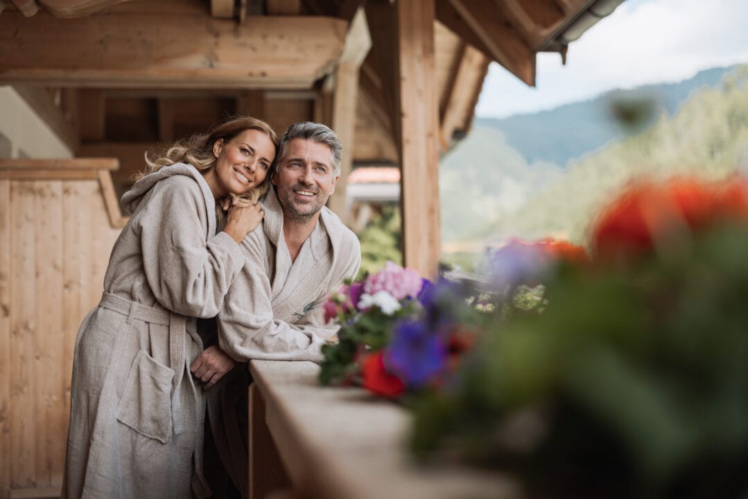 Paar in Bademänteln auf der Terrasse