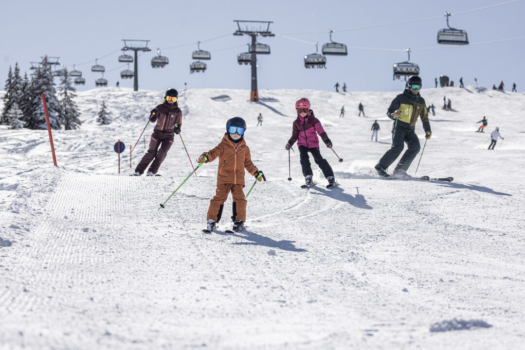 Familie beim Skifahren im Schnee.